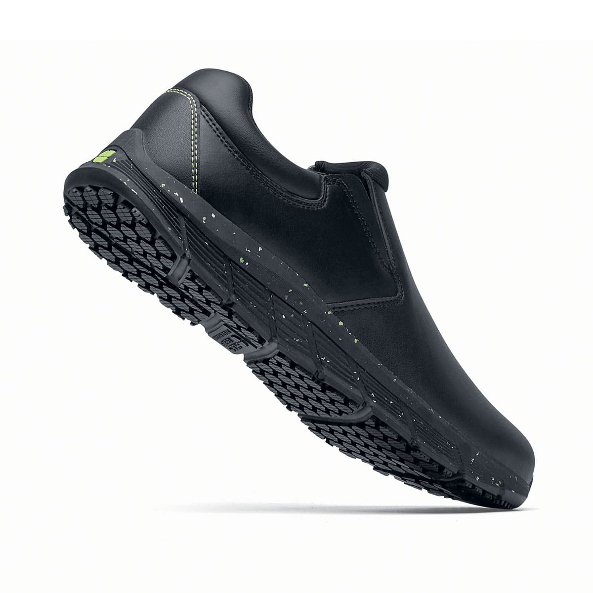 The Shoes for Crews Cater Eco Men's Black is a sustainable, slip-resistant safety shoe, seen perpendicularly and emphasising the heel.