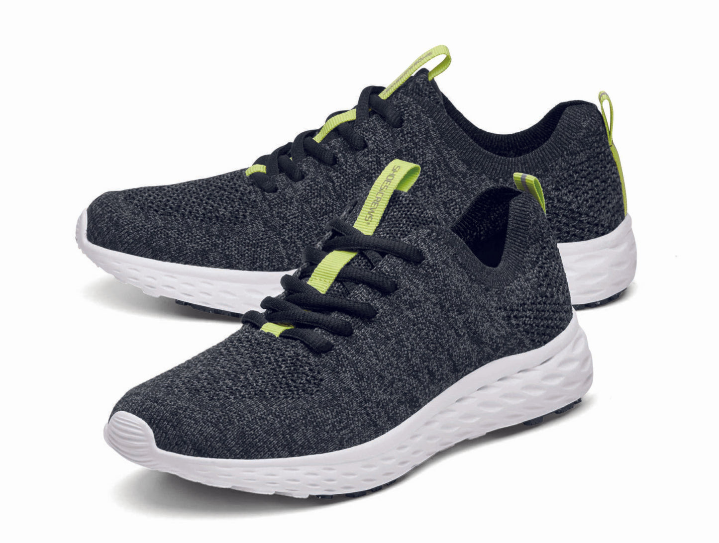 The Everlight™ ECO Womens Black/Grey from Shoes For Crews are lightweight, breathable slip-resistant trainers made from recycled materials, pair seen from the left side, emphasised on the tip of the left shoe.