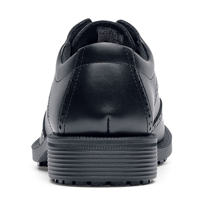 The Executive Wing Tip IV from Shoes For Crews, is an slip resistant dress shoe with a water resistant breathable leather upper to provide industry leading levels of grip and durability, seen from the back.