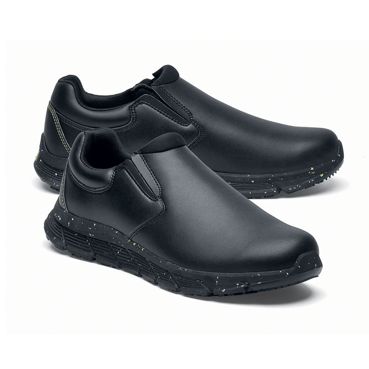 The Shoes for Crews Cater Eco Men's Black is a sustainable, slip-resistant safety shoe, pair seen from the right side, emphasised on the tip of the right shoe.