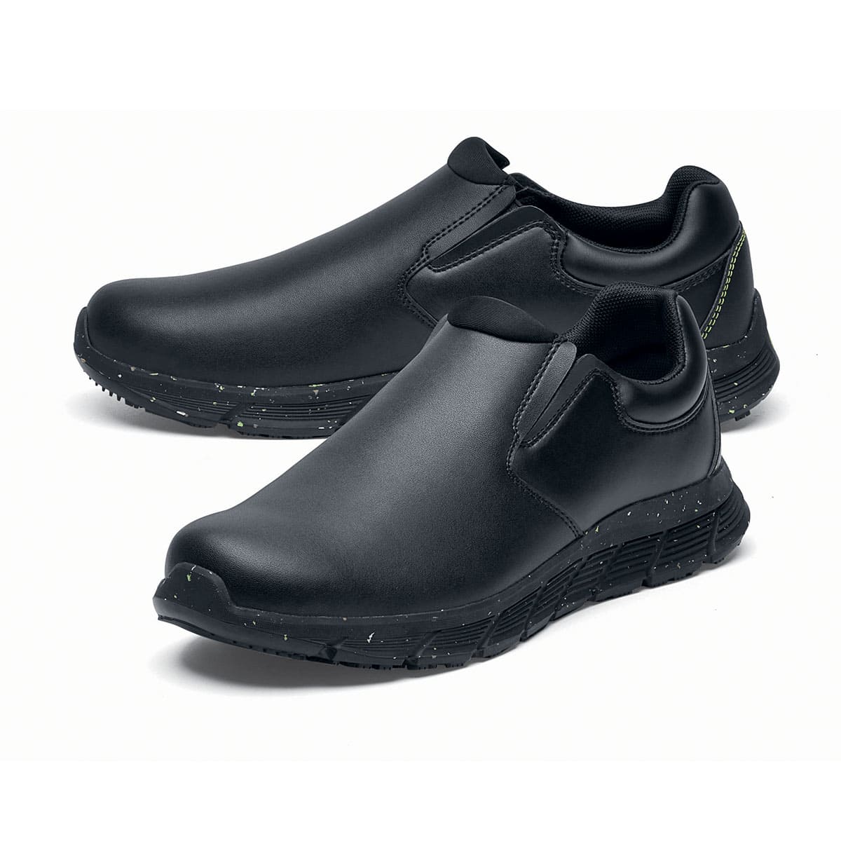 The Shoes for Crews Cater Eco Men's Black is a sustainable, slip-resistant safety shoe, pair seen from the left  side, emphasised on the tip of the left shoe.