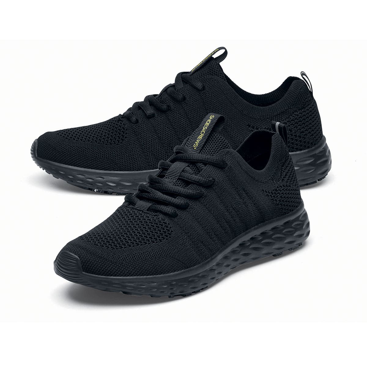 The Everlight™ Everlight Eco Women's Black from Shoes For Crews are lightweight and breathable slip-resistant trainers made from recycled materials, pair seen from the left side, emphasised on the tip of the left  shoe.