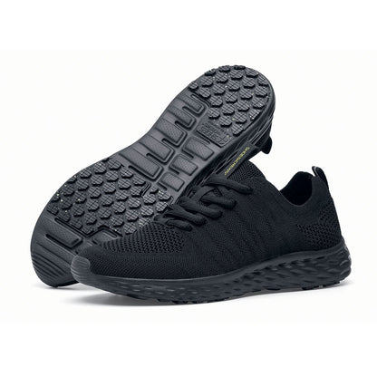 The Everlight™ Everlight Eco Women's Black from Shoes For Crews are lightweight and breathable slip-resistant trainers made from recycled materials,pair seen from the left side and the sole.