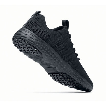 The Everlight™ Everlight Eco Women's Black from Shoes For Crews are lightweight and breathable slip-resistant trainers made from recycled materials, seen from the perpendicular.
